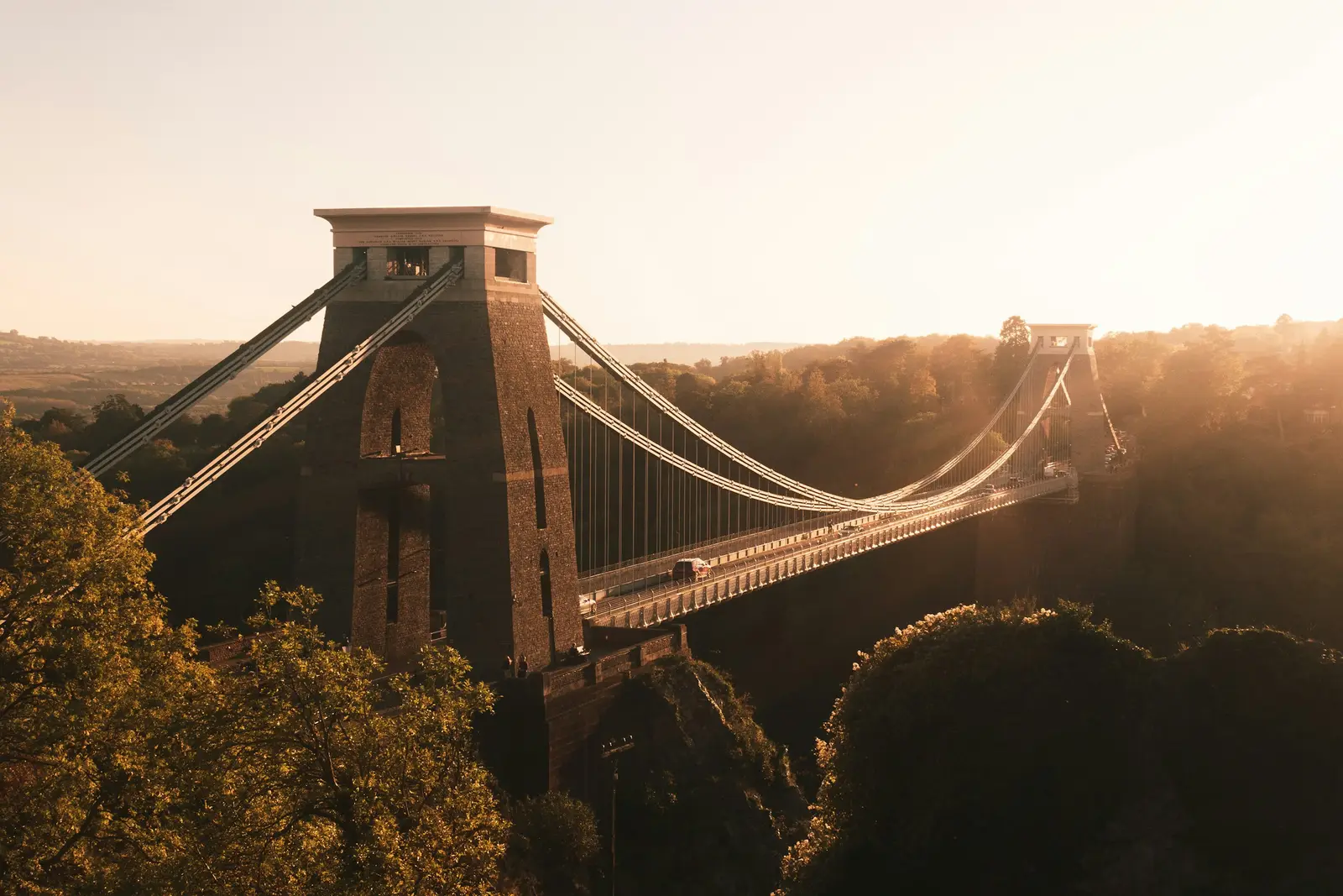 Clifton Suspension Bridge spanning the wooded Avon Gorge at golden hour, Bristol