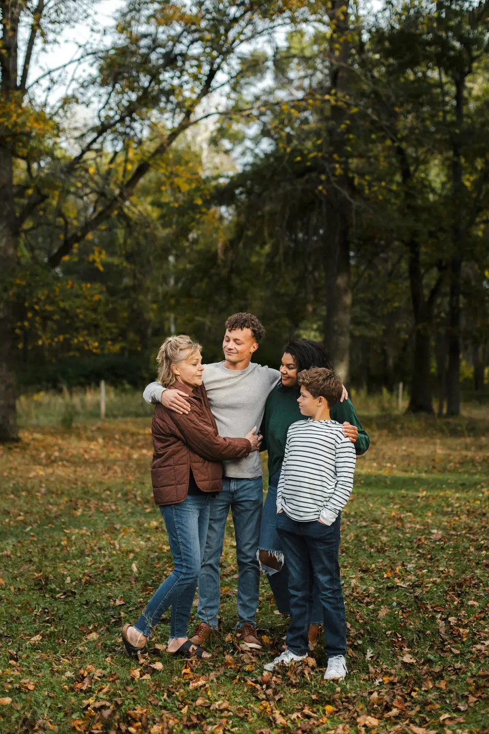 Parents swinging a young child between them in a park