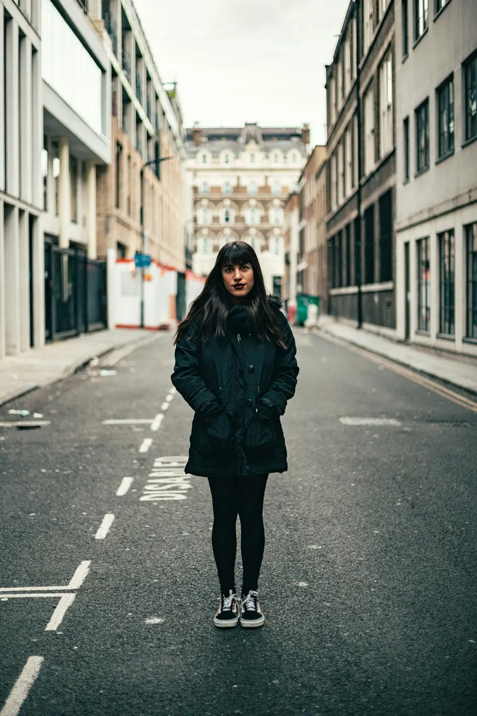 A woman smiling over her shoulder on a colourful London street
